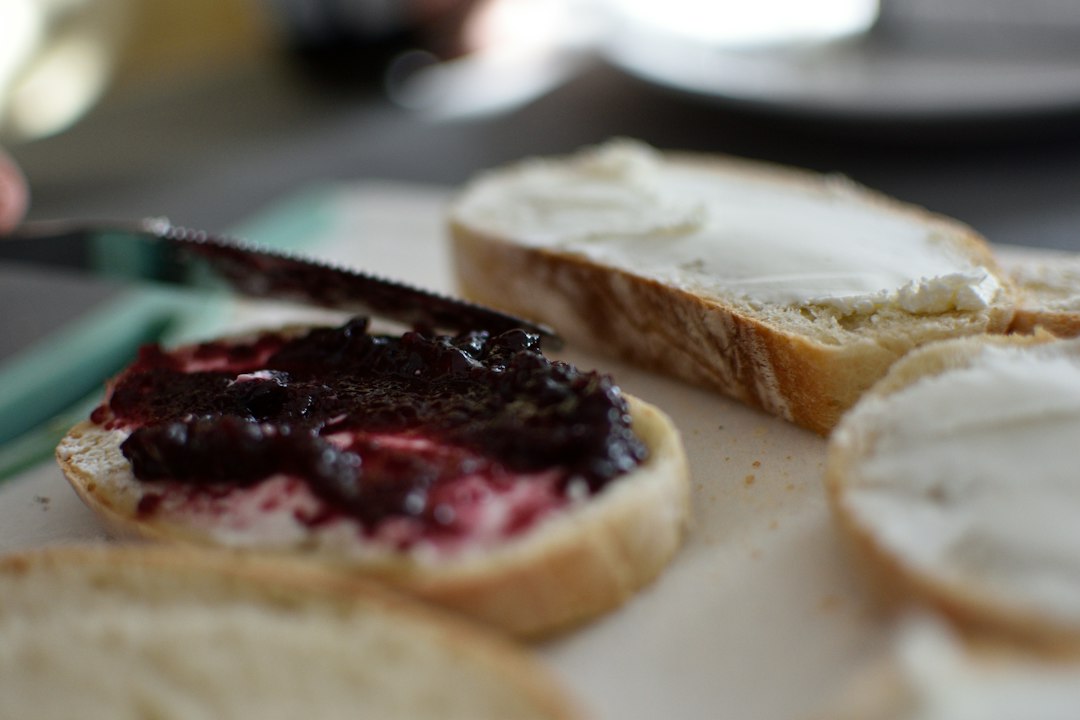 Sliced bread with black and red sauce on white ceramic plate