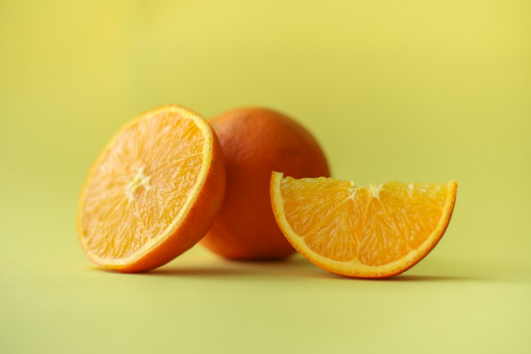 Sliced orange fruit on white table