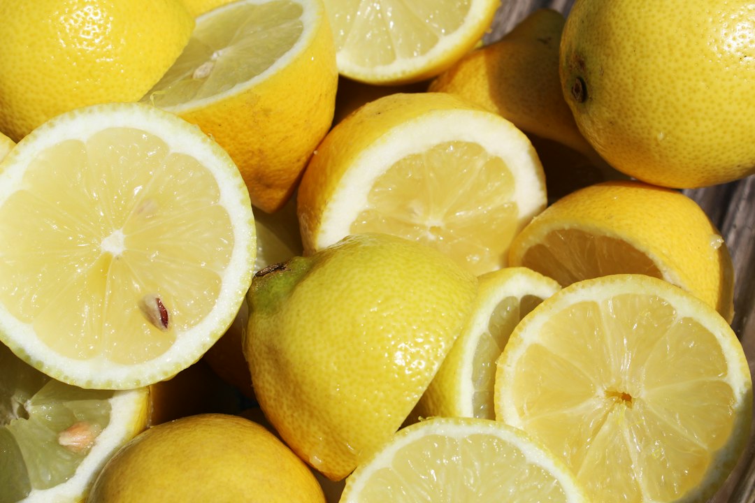 Yellow lemon fruit on white ceramic plate