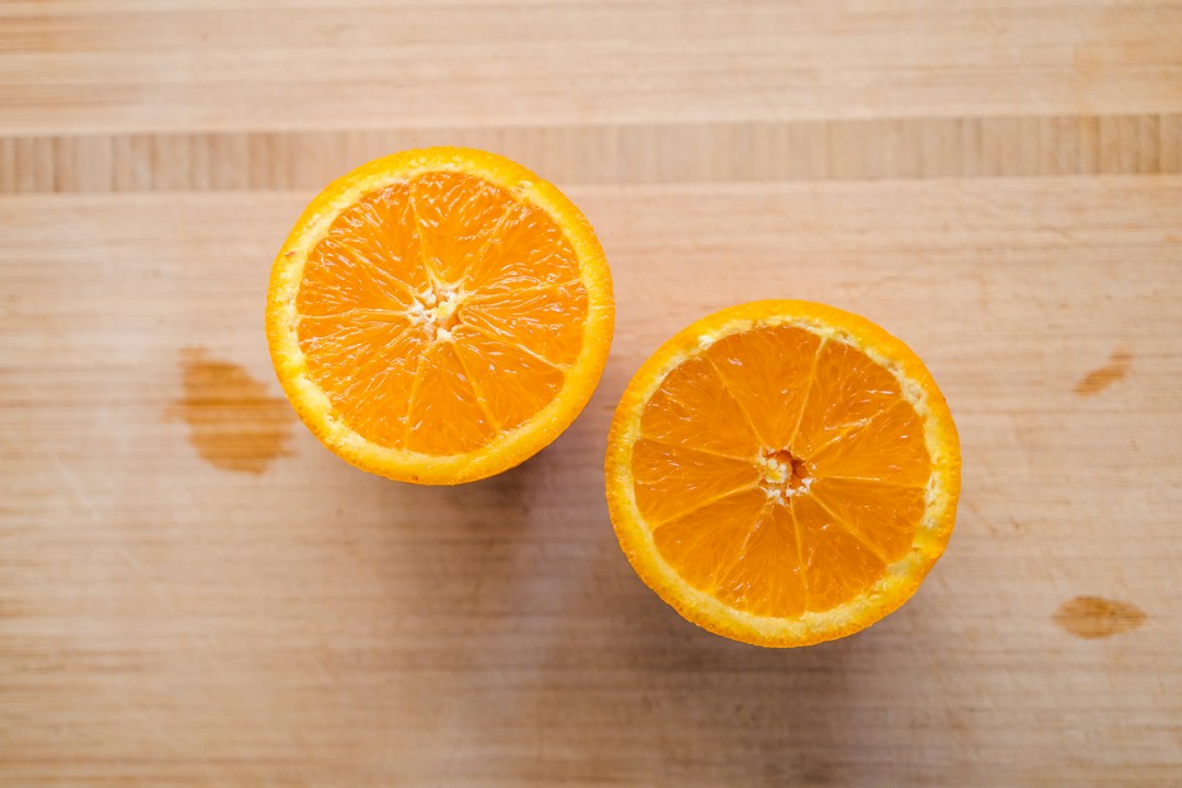 Sliced orange fruit on brown wooden table