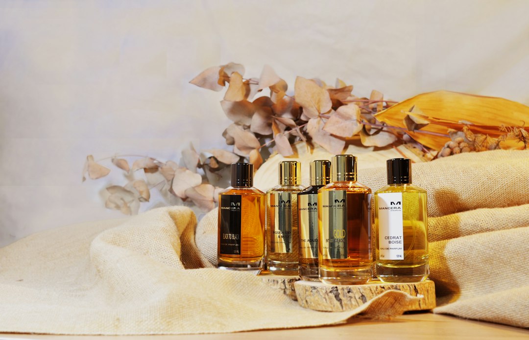 Three bottles of cologne sitting on top of a table