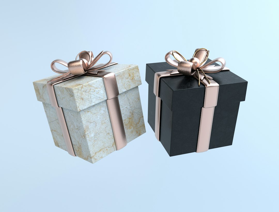 Two black and white boxes with gold bows