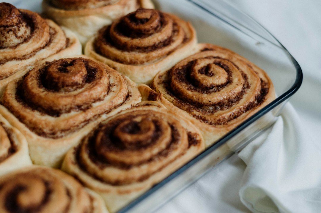 A pan filled with cinnamon rolls on top of a table