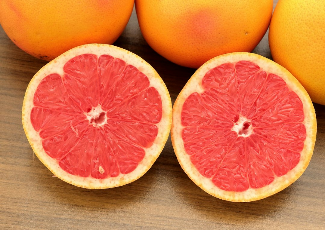 A group of grapefruits sitting on top of a wooden table
