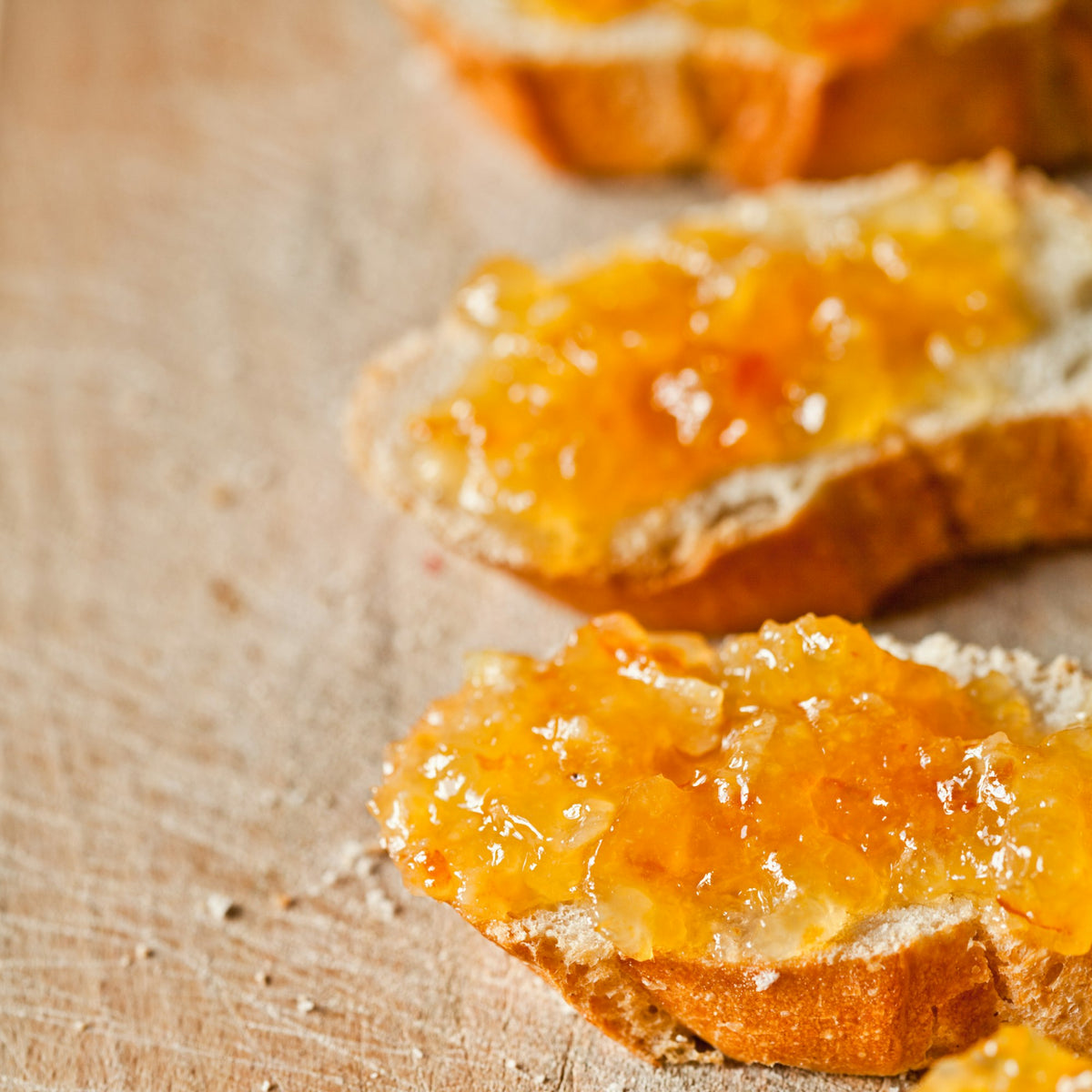 Slices of bread spread with chunky orange marmalade