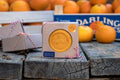 Box of Gill Orange Soap on wooden blocks with oranges in the background