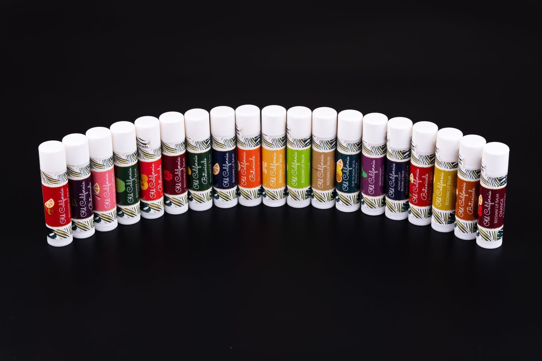 A row of Old California Botanicals beeswax lip balms